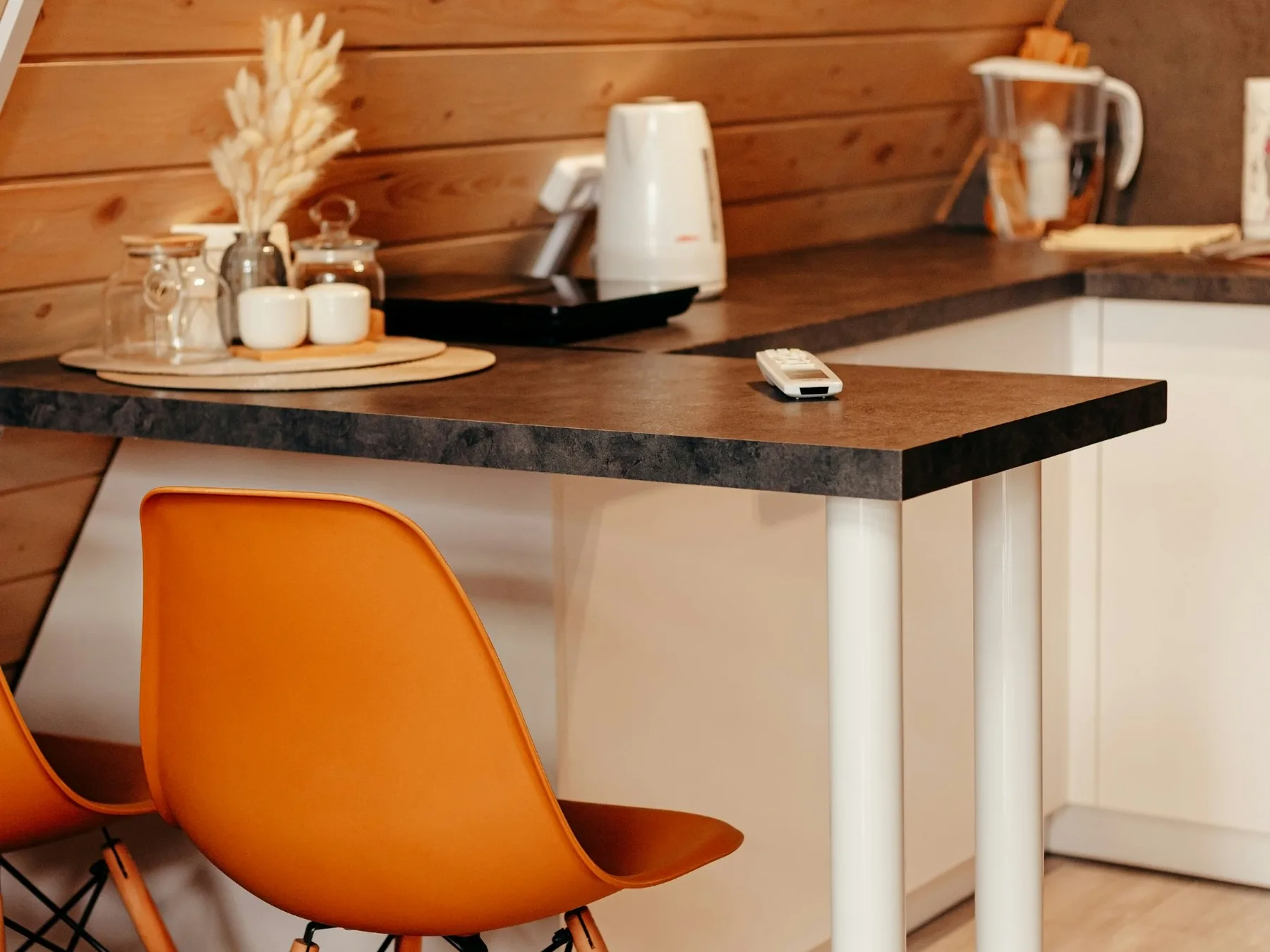 Warm wooden kitchen with a dining table and two chairs